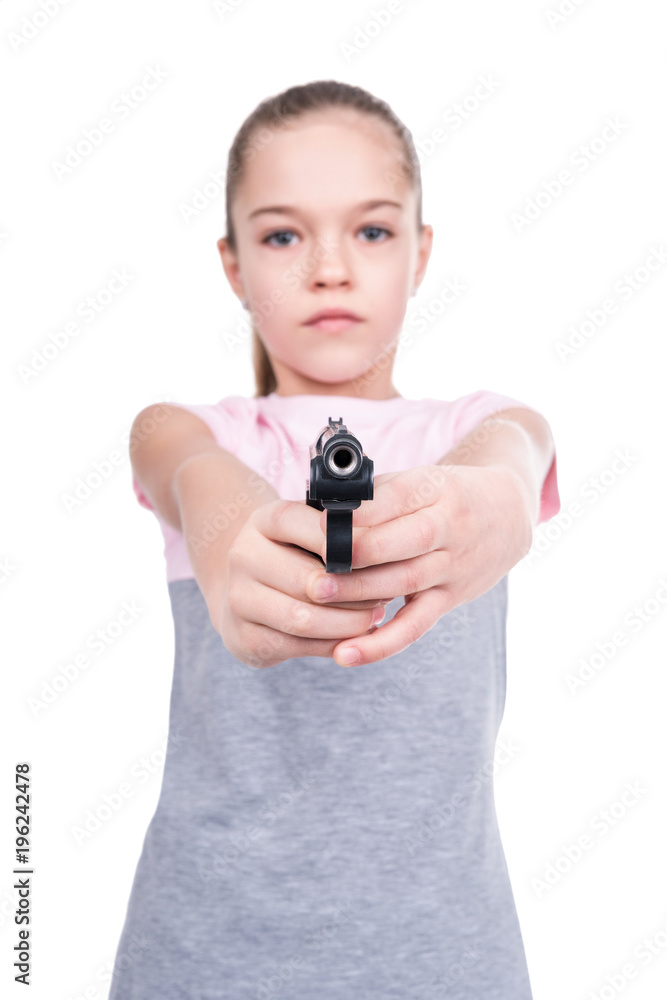 Young girl aiming a gun at the camera, isolated on a white background Young girl aiming a gun at the camera, isolated on a white background