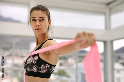 Woman exercising with a resistance band © Jacob Lund
