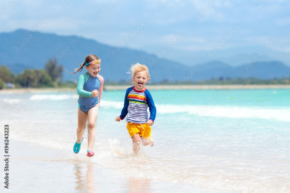 Kids on tropical beach. Children playing at sea. Kids on tropical beach. Children playing at sea.