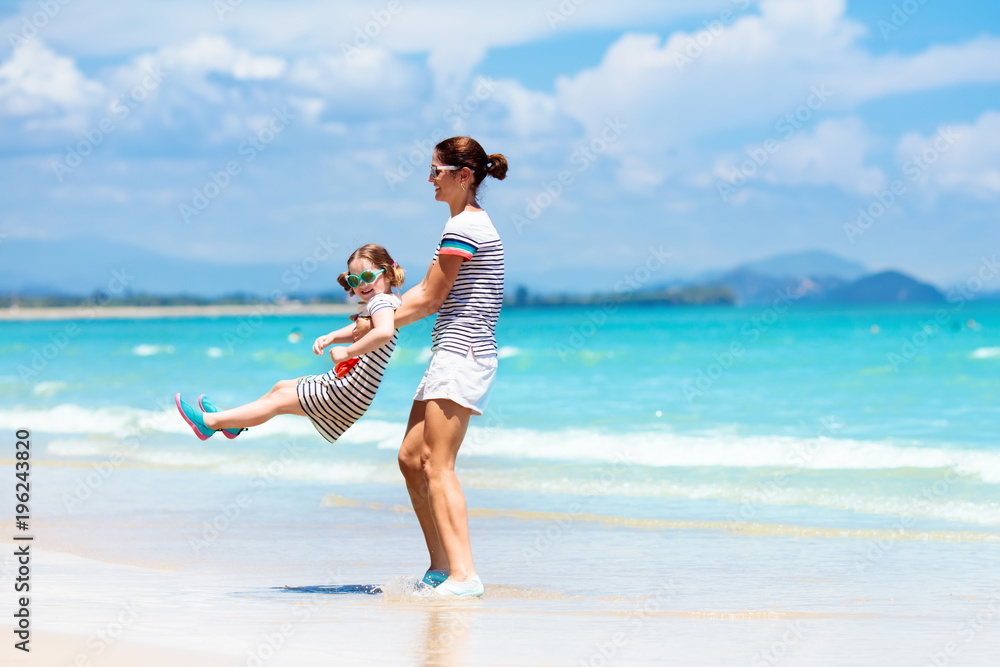 Mother and child on tropical beach. Sea vacation Mother and child on tropical beach. Sea vacation