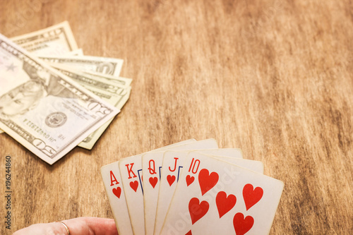 Close-up of a poker player holding playing cards