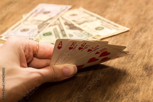 Close-up of a poker player holding playing cards