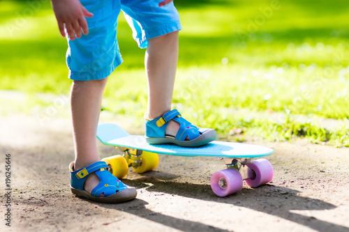 Child riding skateboard in summer park © famveldman