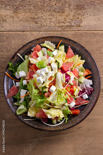 Grapefruit, tomato, lettuce and cucumber salad with feta cheese. Clean eating, healthy and diet food concept. View from above, top