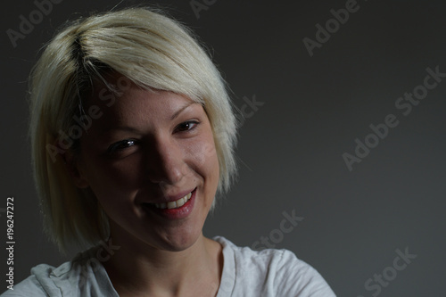 Young blonde girl portrait with big smile