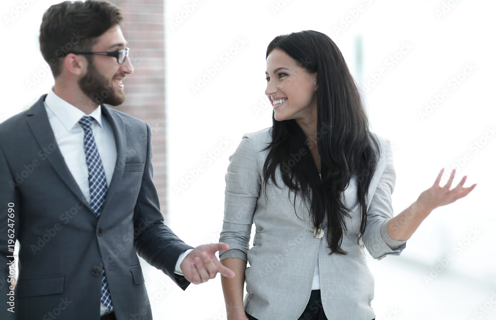 employees of the company discuss working issues standing in the office employees of the company discuss working issues standing in the office