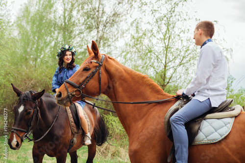 the couple in love have fun and riding on a horses among the nature