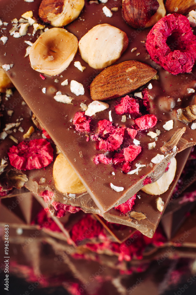 Broken chocolate bars with nuts and sublimated raspberry Broken chocolate bars with nuts and sublimated raspberry