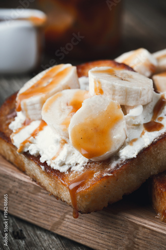 Breakfast  toasts with cream cheese  bananas and caramel sauce