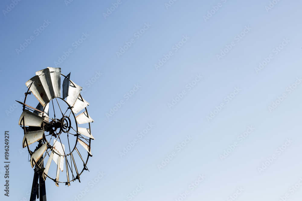 Old fashion windmill against a blue sky