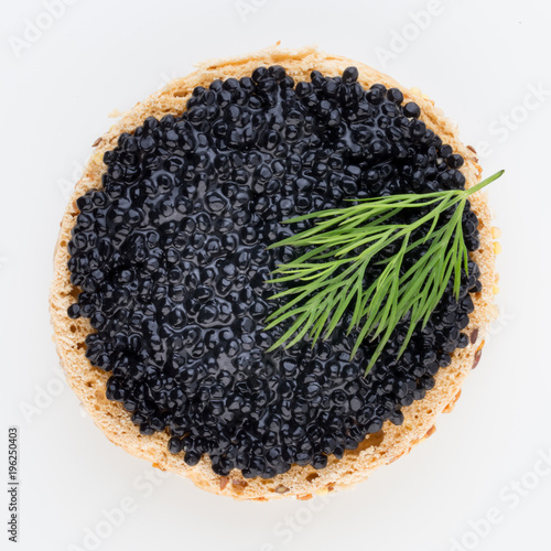 Canapes with black sturgeon caviar and spice isolated on the white background.