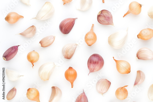 Onion and garlic isolated on white background, top view. Wallpaper abstract composition of vegetables.