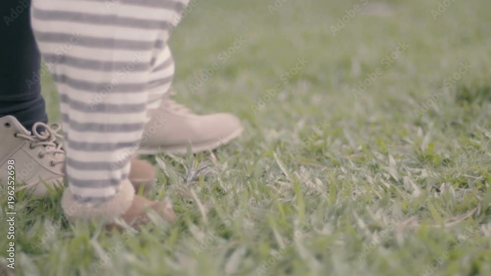 Happy baby boy walking first steps outdoor Happy baby boy walking first steps outdoor