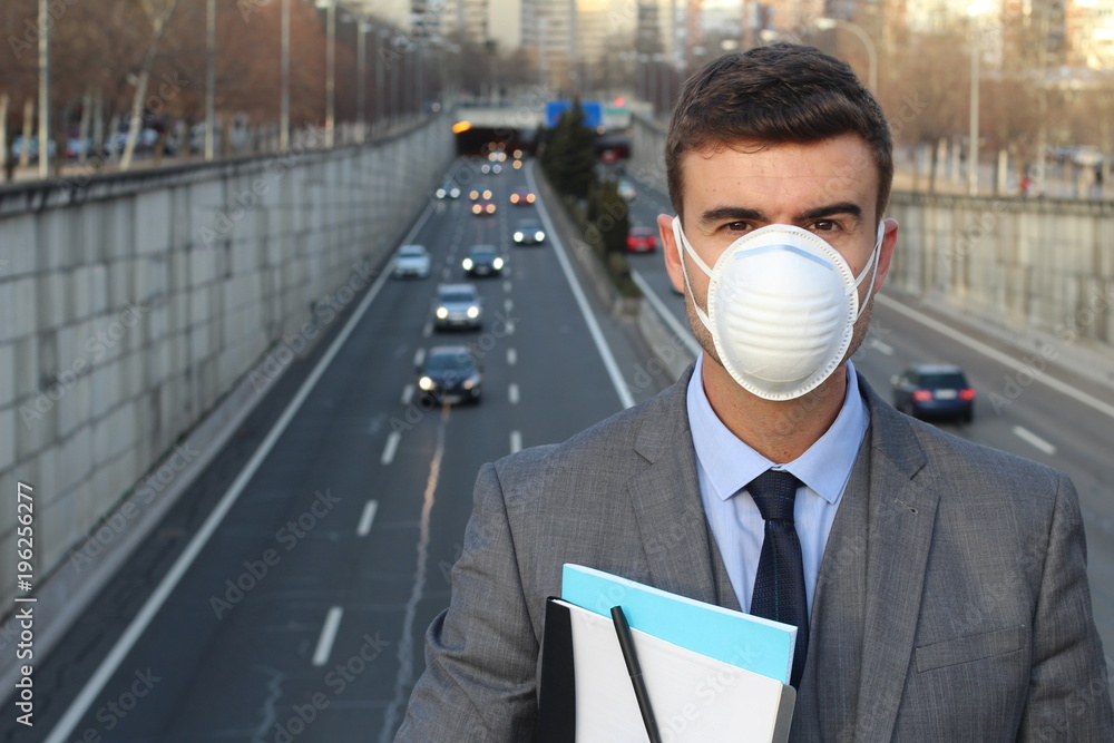 Man wearing a breathing mask in a polluted world Man wearing a breathing mask in a polluted world