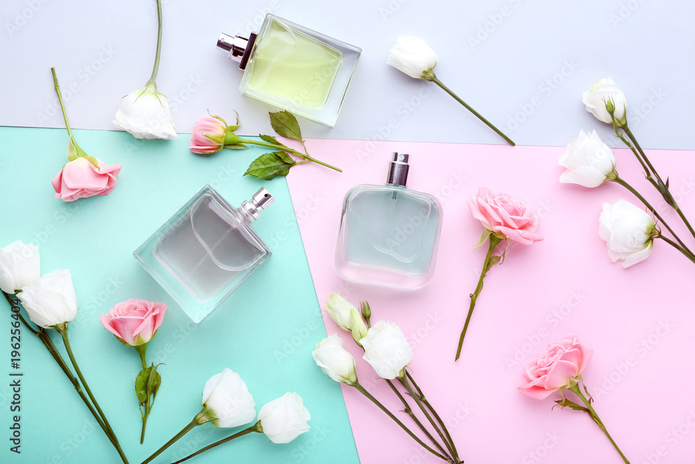 Perfume bottles with flowers on colorful background - obrazy, fototapety, plakaty 