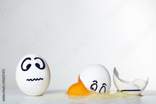 Eggs with funny faces on grey background