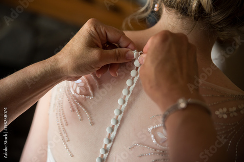 Wedding dress being buttoned