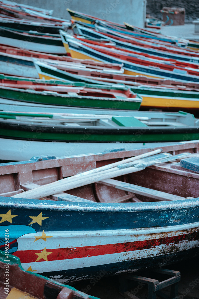 Multicolored local fishing boats waiting on the coast of good weather. Ponta do Sol Santo Antao Cape Verde