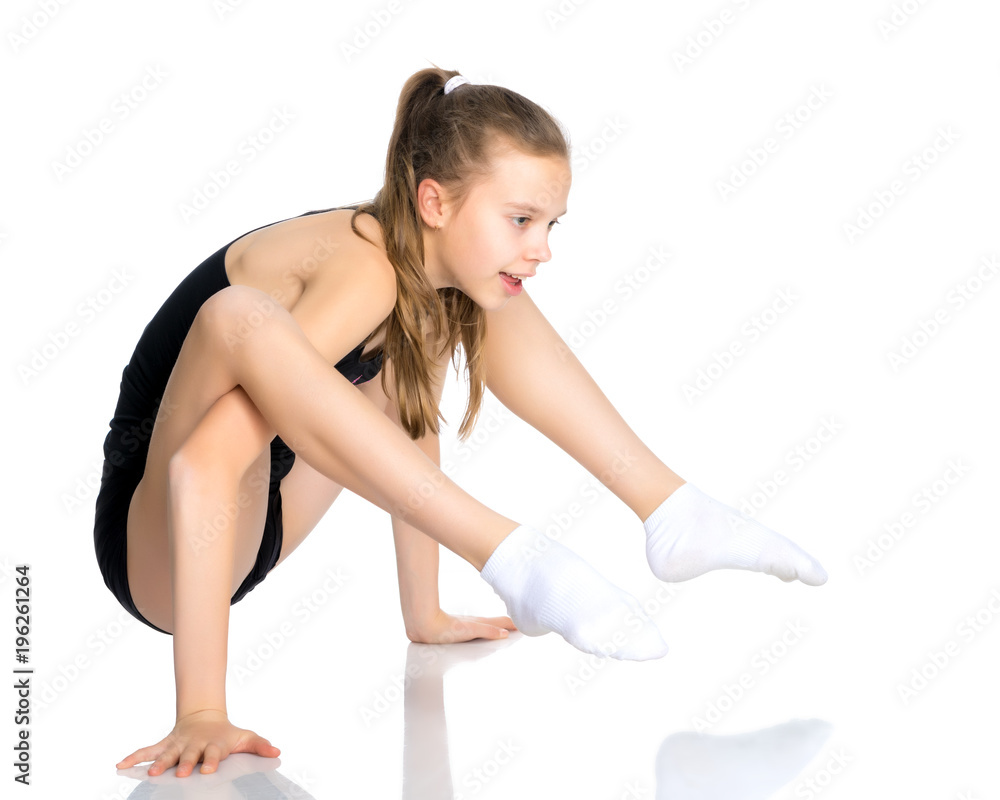 The gymnast perform an acrobatic element on the floor. The gymnast perform an acrobatic element on the floor.