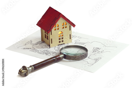 Research of property: loan, rent, property, housing, mortgage. Wooden house on map with magnifying glass isolated on white. Сoncept for jurist, legal, juristic legislation, consulting, real estate photo