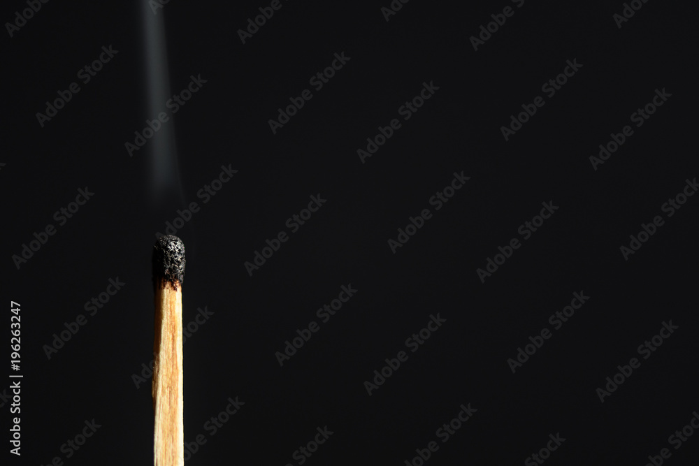 Match with the burned head on a black background closeup Match with the burned head on a black background closeup