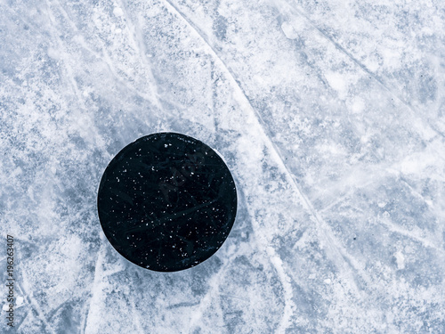 hockey puck on the ice and snow texture, copyspace and text