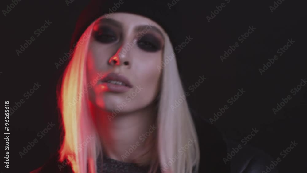 beautiful blonde girl with black glasses posing in studio with red light beautiful blonde girl with black glasses posing in studio with red light
