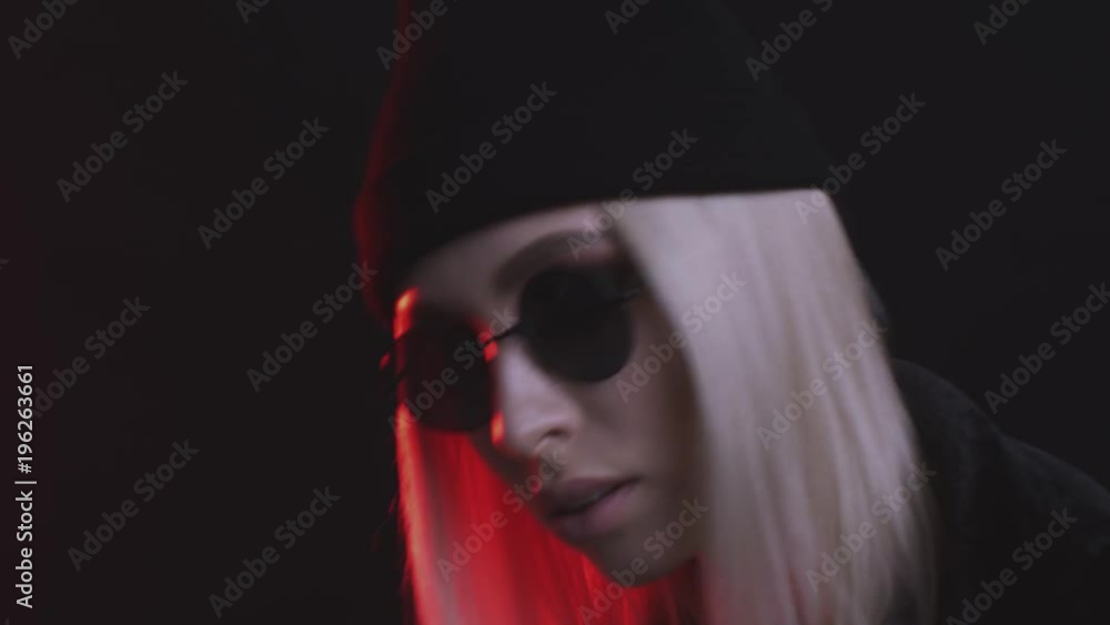 beautiful blonde girl with black glasses posing in studio with red light beautiful blonde girl with black glasses posing in studio with red light