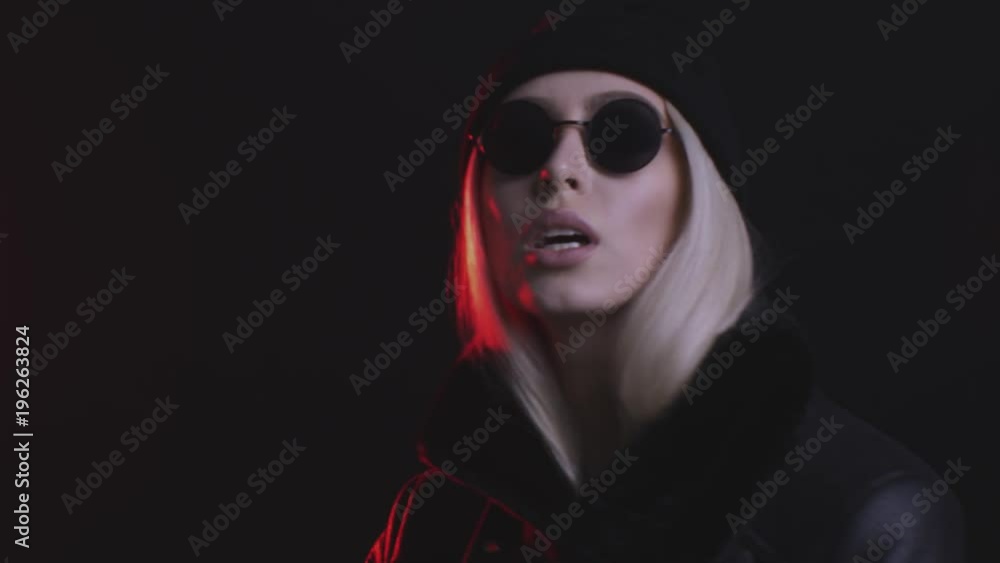 beautiful blonde girl with black glasses posing in studio with red light beautiful blonde girl with black glasses posing in studio with red light