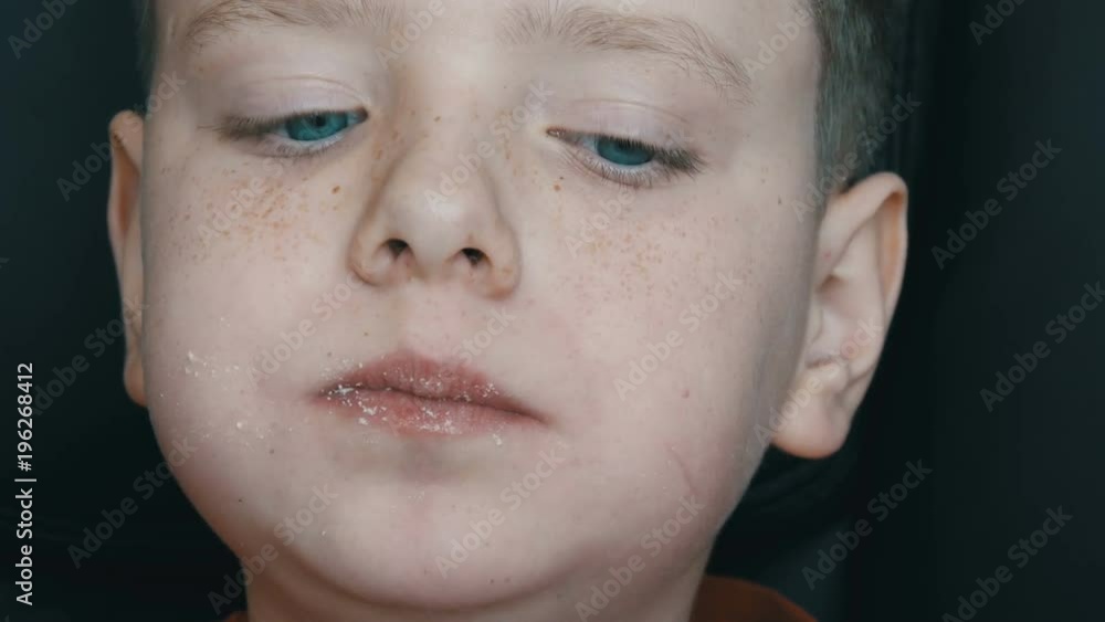 Blue-eyed, freckled teenager boy eating large sweet marshmallows. Problem of eating sugar, diabetes mellitus Blue-eyed, freckled teenager boy eating large sweet marshmallows. Problem of eating sugar, diabetes mellitus