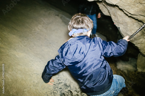 children explore underground caves, an underground karst complex of Cunardo, Lombardy, Italy