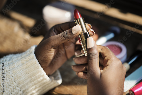 Woman using lipstick