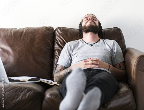 Caucasian man taking a break from work by listening to music