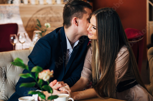 Couple in love kissing at bar eating in restautant