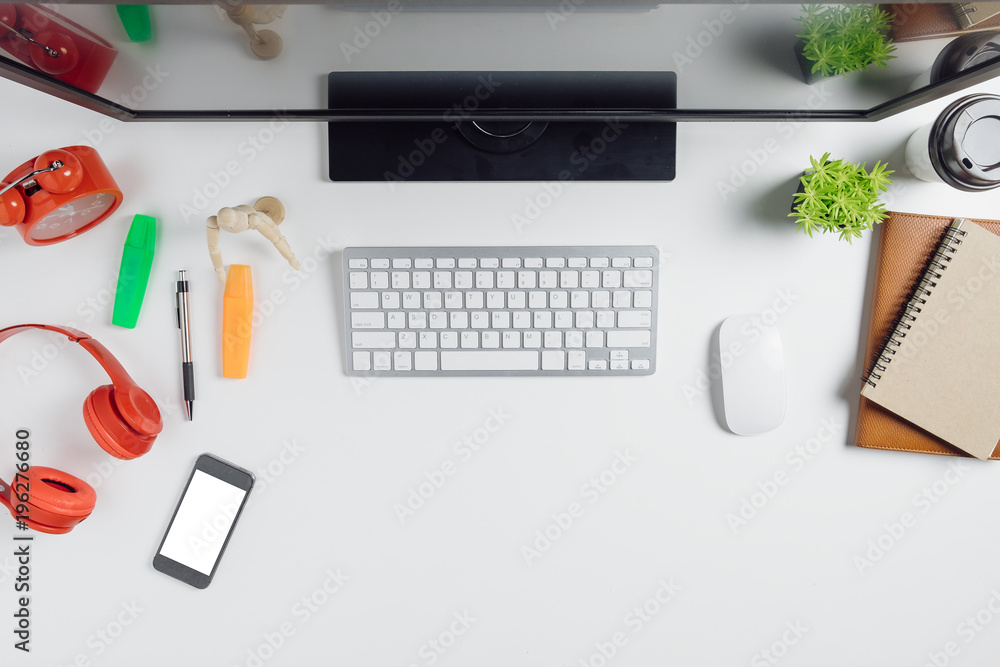 Modern White office desk table with computer,smart phone,notebook and cup of coffee.Top view with copy space.Working desk table concept. Modern White office desk table with computer,smart phone,notebook and cup of coffee.Top view with copy space.Working desk table concept.