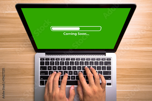 Coming soon Concept Laptop Screen With Typing Hands On Keyboard