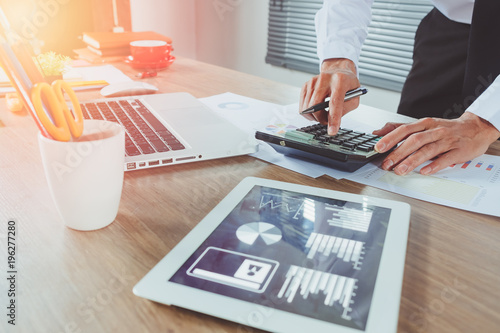 Businessman hand working with financial about cost photo