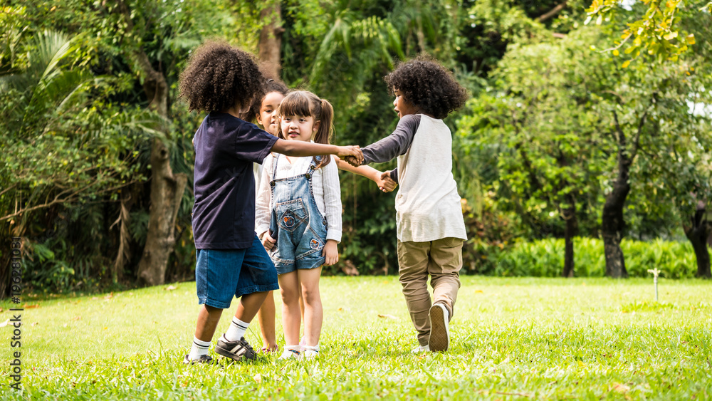 Fototapeta premium Group of children playing together in the park