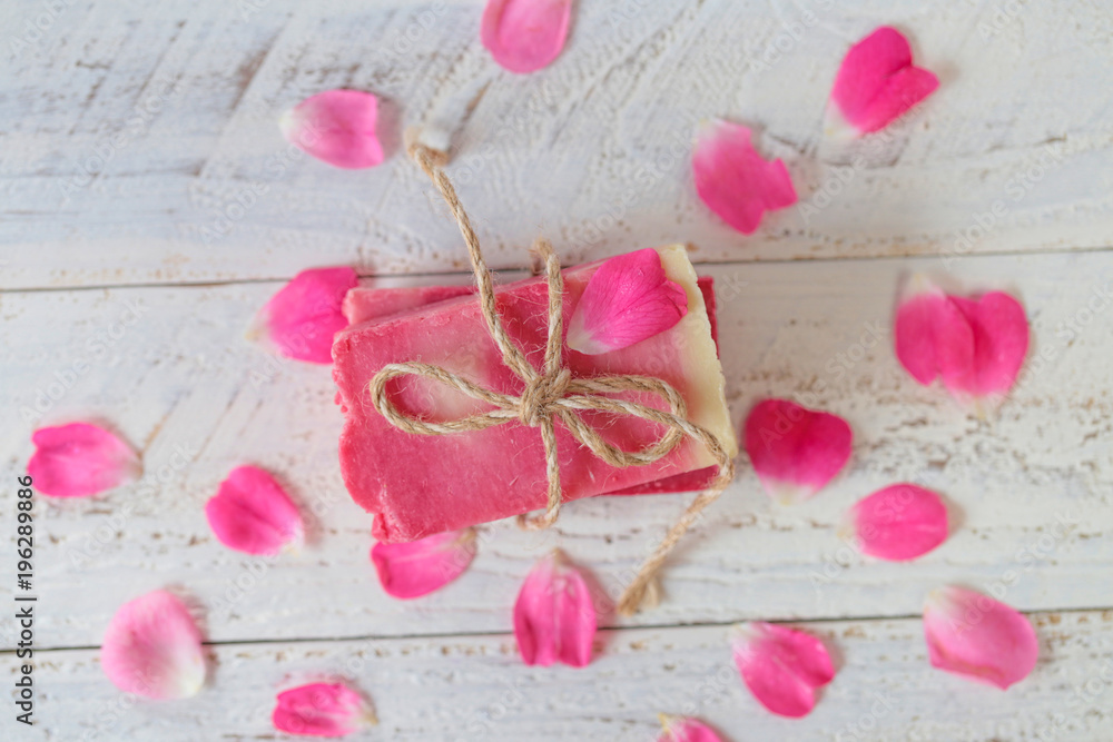 Soap with Rose Extract.Handmade soap with rose extract and rose petals on wooden plank background. Organic Vegetable Cosmetics Concept.vegan soap with rose fragrance Soap with Rose Extract.Handmade soap with rose extract and rose petals on wooden plank background. Organic Vegetable Cosmetics Concept.vegan soap with rose fragrance