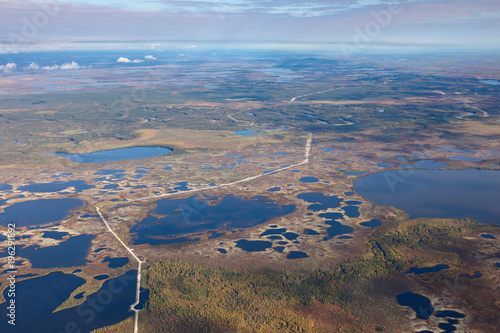 Top view of gas pipeline in endless swamps in tundra photo