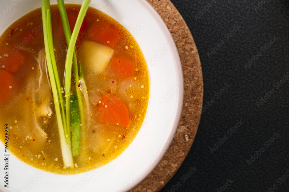homemade chicken soup in white plate on black background homemade chicken soup in white plate on black background