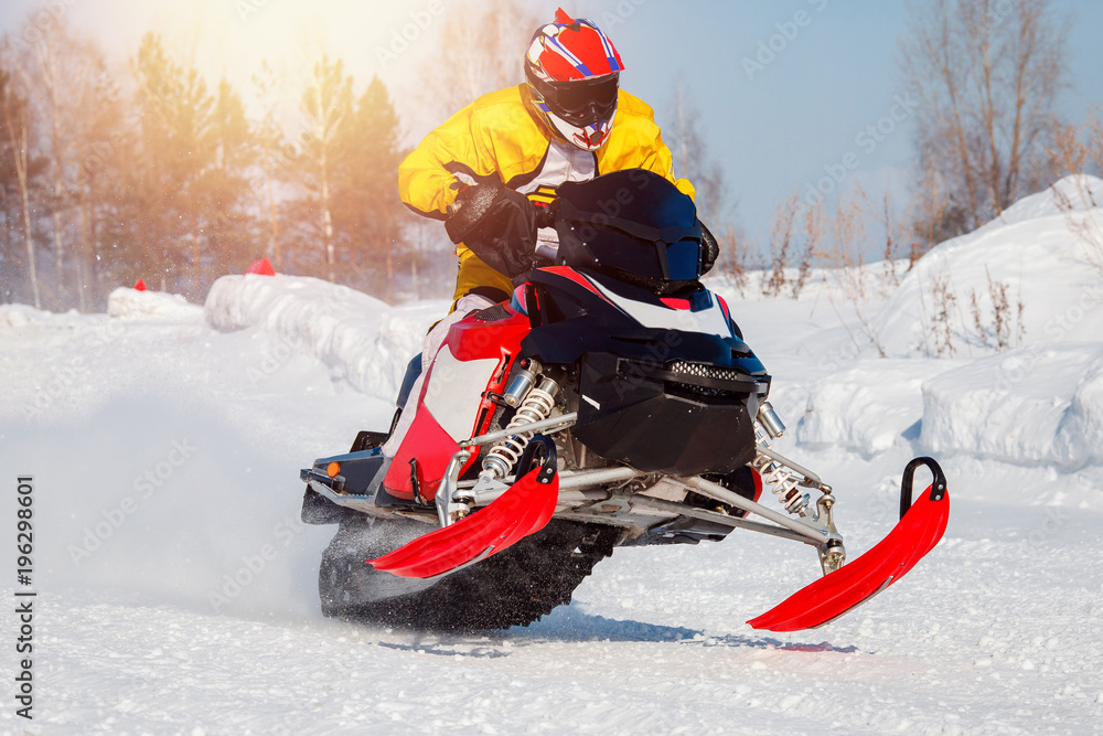 Snowmobile. Snowmobile races jump in snow. Concept winter sports, racers.