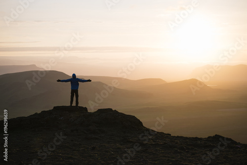 Photography Tourist at sunrise in the mountains