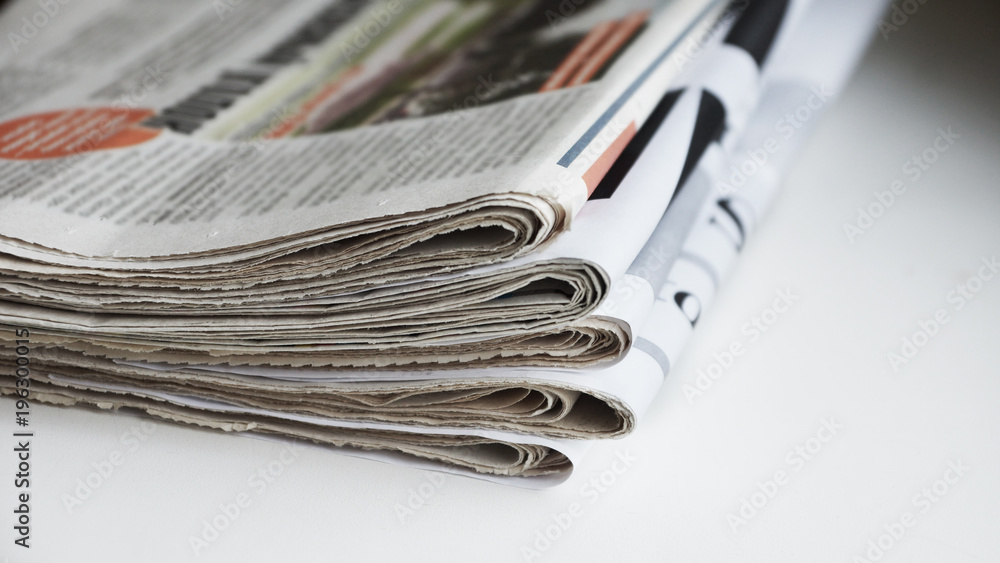 News - folded newspapers stacked in a pile. Concept for information News - folded newspapers stacked in a pile. Concept for information