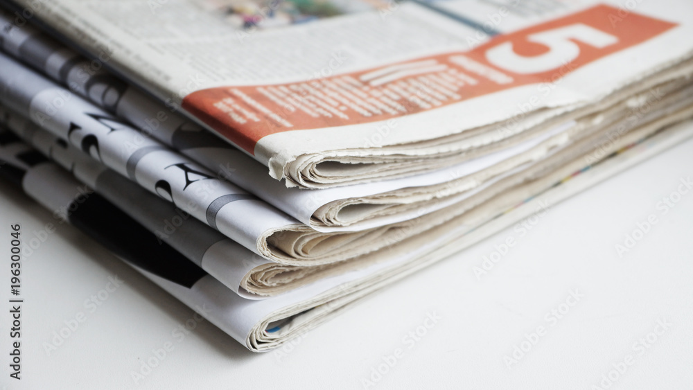 News - folded newspapers stacked in a pile. Concept for information News - folded newspapers stacked in a pile. Concept for information