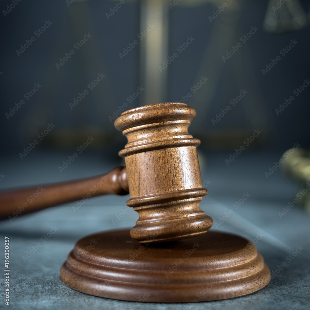 Law and Justice concept. Mallet of the judge, books, scales of justice. Gray stone background, reflections on the floor, place for typography. Courtroom theme. Law and Justice concept. Mallet of the judge, books, scales of justice. Gray stone background, reflections on the floor, place for typography. Courtroom theme.