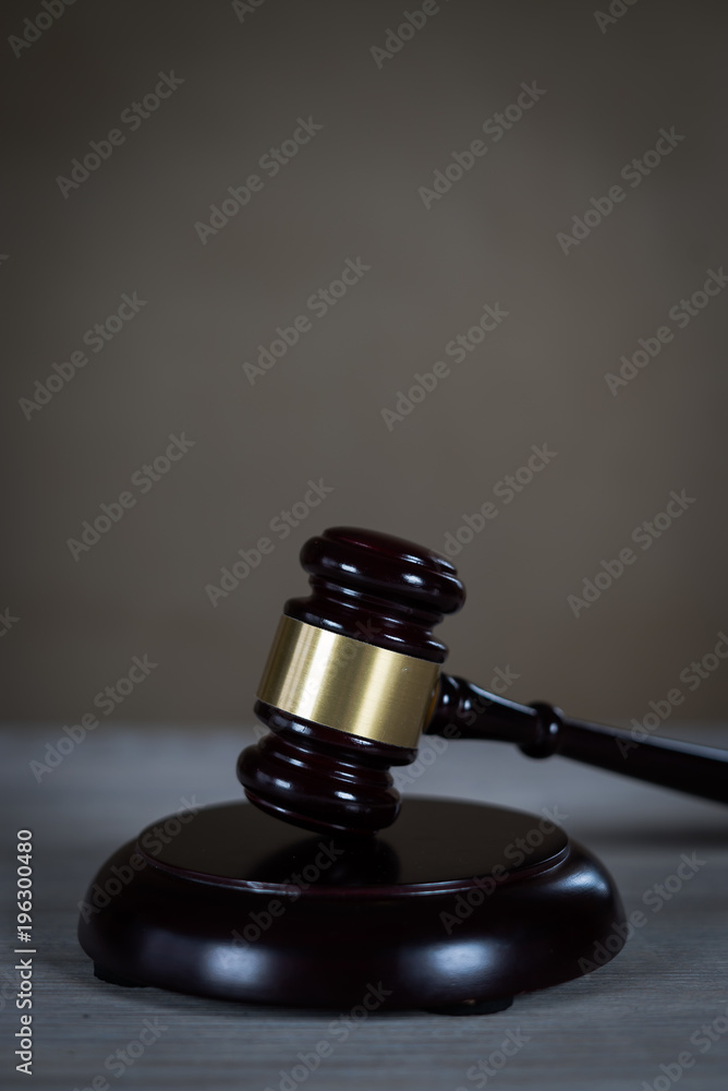 Law and Justice concept. Mallet of the judge, books, scales of justice. Gray stone background, reflections on the floor, place for typography. Courtroom theme. Law and Justice concept. Mallet of the judge, books, scales of justice. Gray stone background, reflections on the floor, place for typography. Courtroom theme.