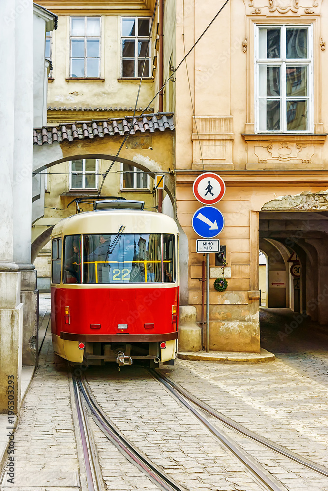 red vintage tram in the old streets of Prague