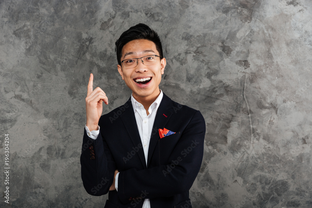 Portrait of a happy young asian man dressed in suit Portrait of a happy young asian man dressed in suit