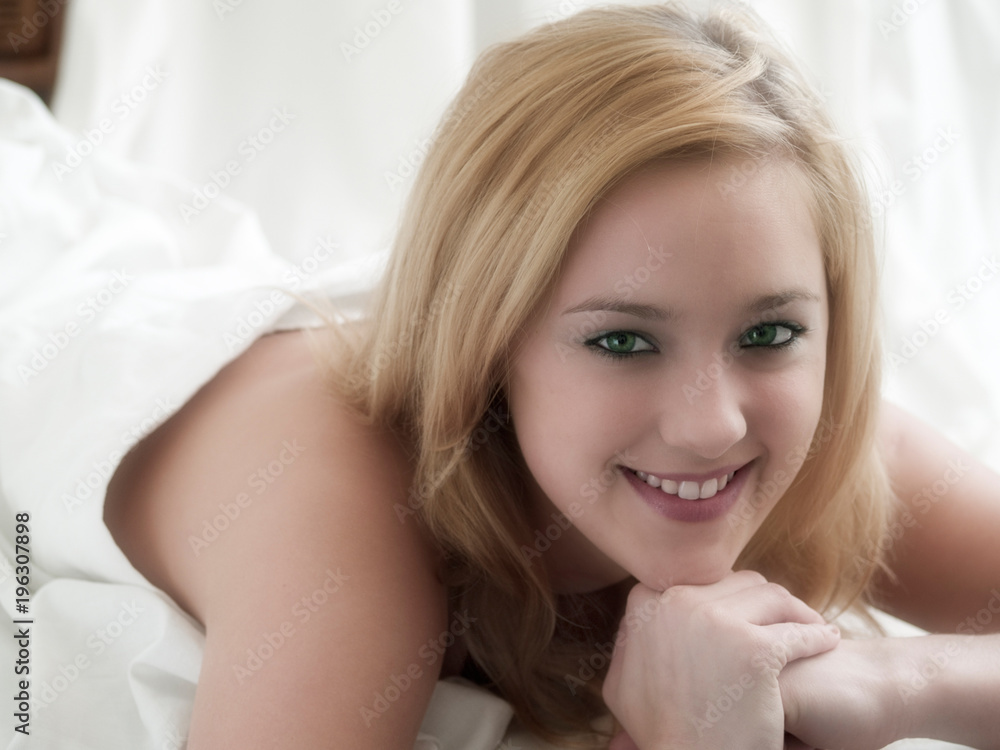 pretty young blonde woman lying in bed pretty young blonde woman lying in bed
